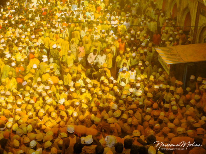 Huge crowd at Khandoba Temple. Turmeric being thrown from rooftops on the huge crowd